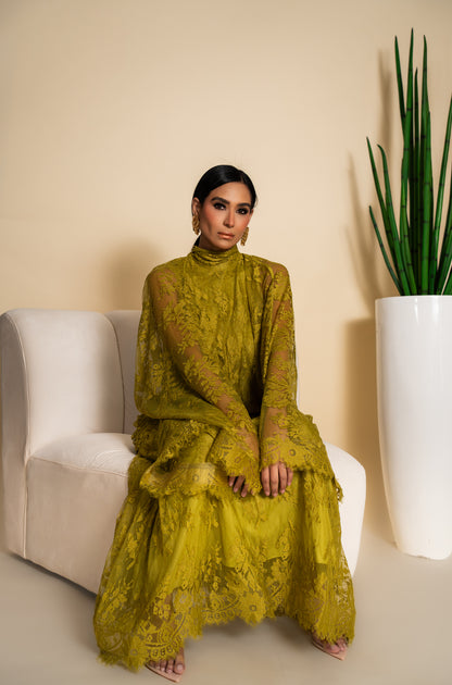 Elegant olive green lace dress with dramatic sleeves and intricate floral detailing