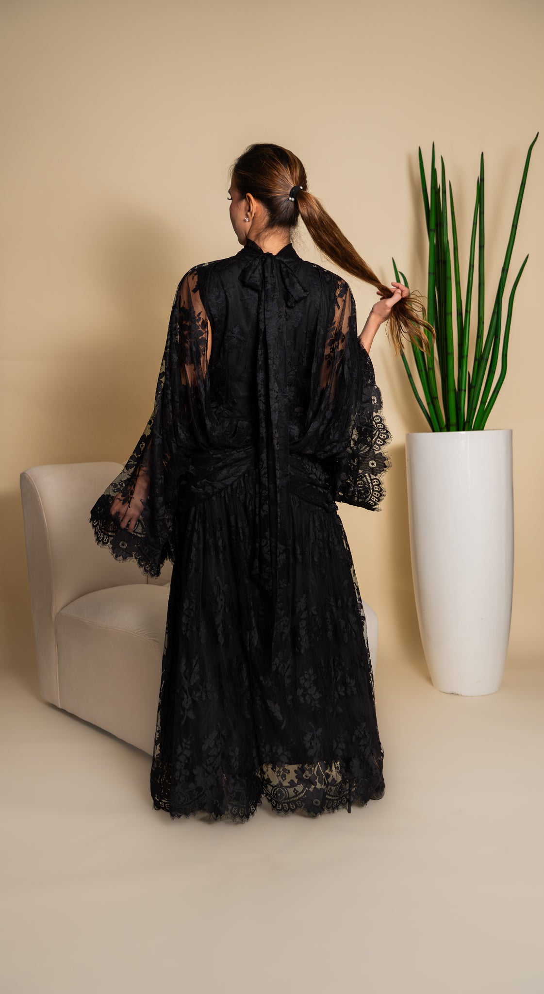 Elegant black lace dress with intricate detailing.
