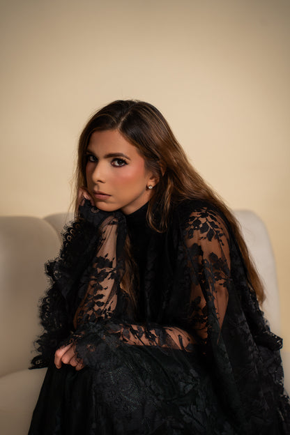 Elegant black lace dress with intricate detailing.